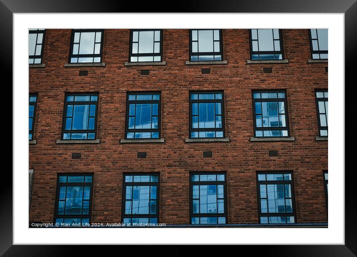 Symmetrical brick building facade with rows of blue windows, urban architecture background in Leeds, UK. Framed Mounted Print by Man And Life