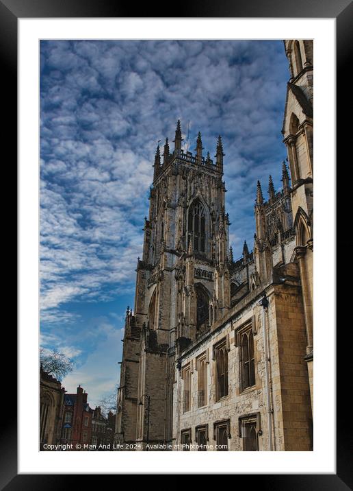 Gothic cathedral against a dramatic sky with fluffy clouds, showcasing intricate architecture and historical grandeur, ideal for travel and cultural themes in York, North Yorkshire, England. Framed Mounted Print by Man And Life