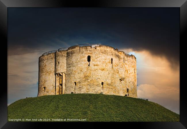 Dramatic sky over an ancient stone fortress atop a lush green hill, symbolizing historical strength and medieval architecture in York, North Yorkshire, England. Framed Print by Man And Life