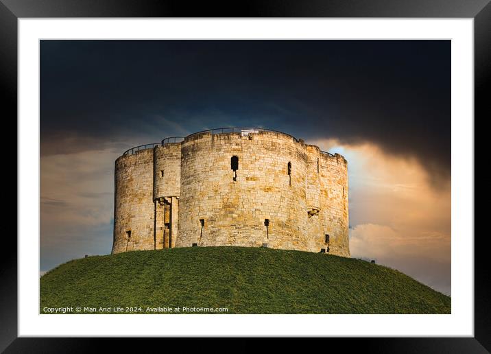 Dramatic sky over an ancient stone fortress atop a lush green hill, symbolizing historical strength and medieval architecture in York, North Yorkshire, England. Framed Mounted Print by Man And Life