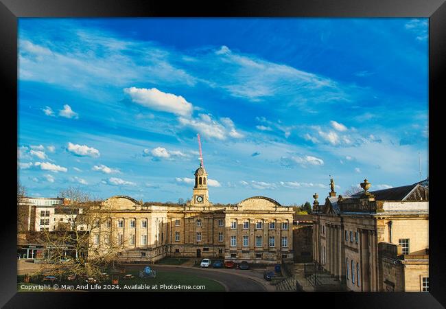 Historic building with a clock tower under a blue sky with fluffy clouds in York, North Yorkshire, England. Framed Print by Man And Life