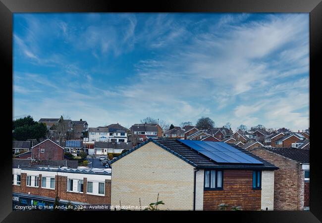 Suburban landscape with residential houses featuring solar panels under a dynamic blue sky with wispy clouds, showcasing sustainable living in a modern neighborhood in Harrogate, North Yorkshire. Framed Print by Man And Life