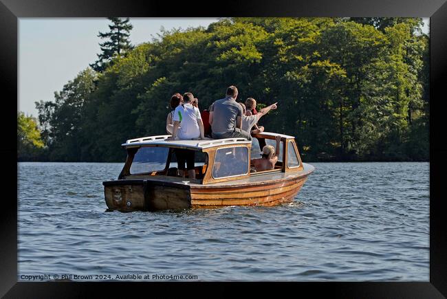 Family on small wooden motor launch, Windermere, Lake District. Framed Print by Phil Brown