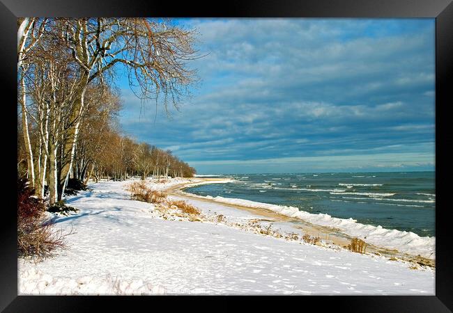 Snow on lake shore in Winter Framed Print by Pete Klinger