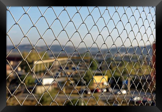 Wire fence to protect the industrial landscape Framed Print by Adrian Bud