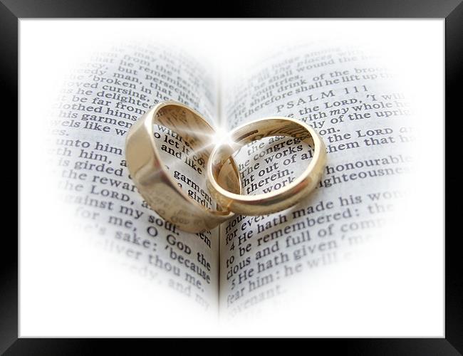 Wedding rings on an open Bible Framed Print by Pete Holloway