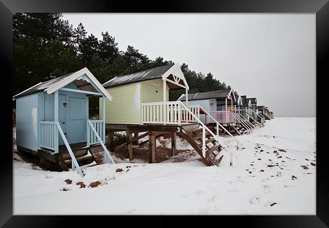 Pastel Beach Huts amid the Snow Framed Print by Paul Macro