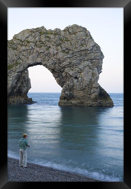 Man fishing at Durdle Door near Lulworth cove. Framed Print by Ian Middleton