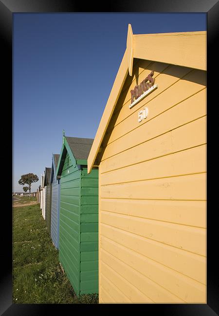 Colourful beach huts in Calshot. Framed Print by Ian Middleton