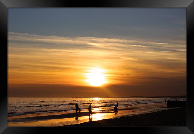  setting of the sun at the beach Framed Print by Oxon Images