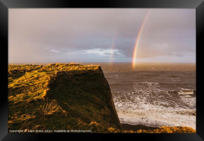 Rainbow and stormy sky at sunset. Sheringham, Norfolk, UK. Framed Print by Liam Grant