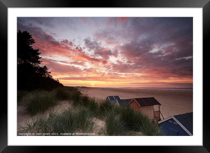 Sunset, beach huts and dunes at Wells-next-the-sea. Norfolk, UK. Framed Mounted Print by Liam Grant