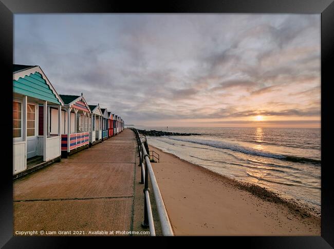 UK, Suffolk, Southwold, colourful beach huts and promenade at sunrise Framed Print by Liam Grant