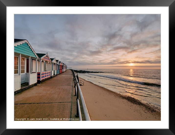 UK, Suffolk, Southwold, colourful beach huts and promenade at sunrise Framed Mounted Print by Liam Grant