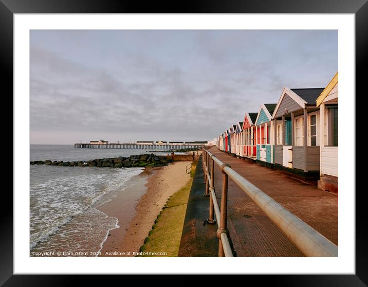 UK, Suffolk, Southwold pier and colourful beach huts at sunrise Framed Mounted Print by Liam Grant