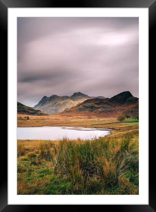 Clouds over Blea Tarn with Langdale Pikes beyond. Framed Mounted Print by Liam Grant