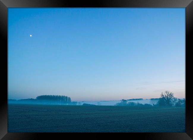 Moon over mist covered rural scene. Framed Print by Liam Grant