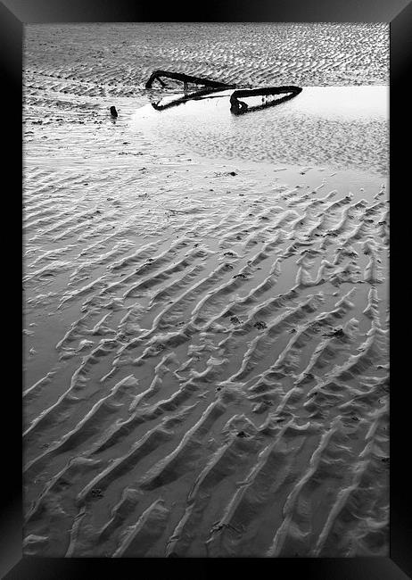 Metal embedded in the sand at low tide. Framed Print by Liam Grant