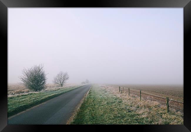 Morning frost and fog over rural country road. Framed Print by Liam Grant