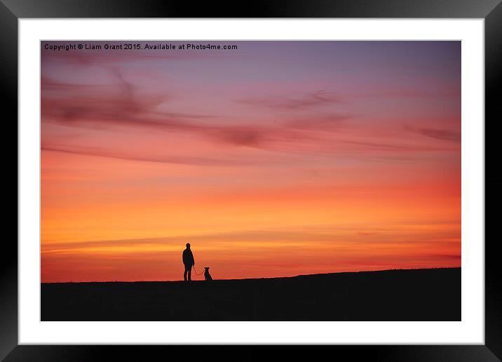 Female walking her dog, silhouetted at sunset. Wal Framed Mounted Print by Liam Grant