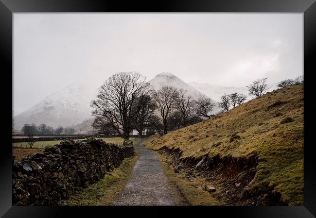Snow blizzard and footpath to a remote cottage. Cu Framed Print by Liam Grant