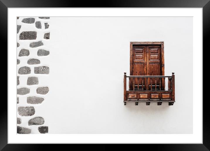 Wooden window door and balcony in a white wall. La Framed Mounted Print by Liam Grant