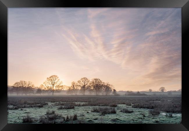 Sunrise and mist on a frosty morning. Norfolk, UK. Framed Print by Liam Grant