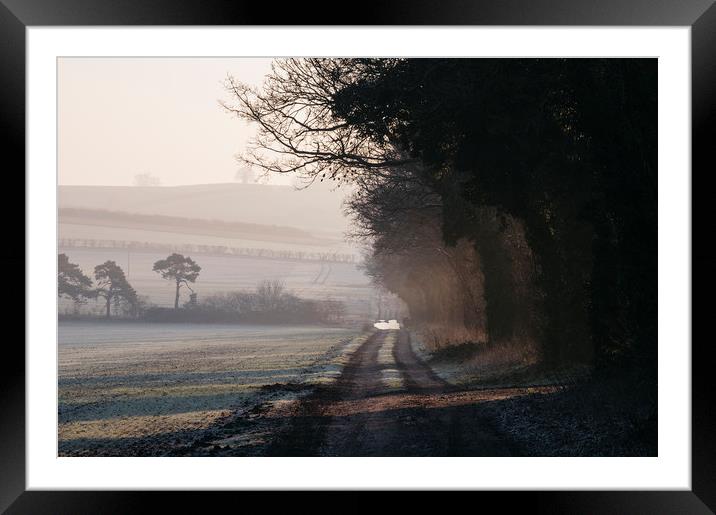 Rays of sunlight and frost along a remote country  Framed Mounted Print by Liam Grant