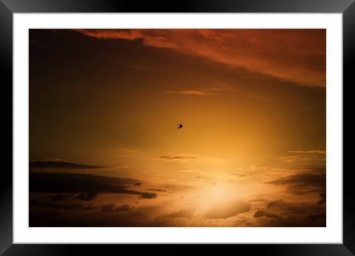 Helicopter at sunset Framed Mounted Print by Ian Jeffrey