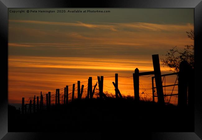 Sunset through the fence Framed Print by Pete Hemington