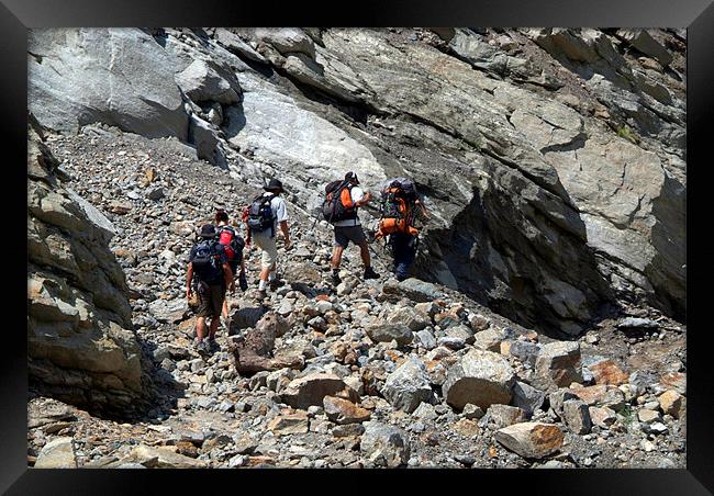 Trekkers Climbing over Landslide Framed Print by Serena Bowles