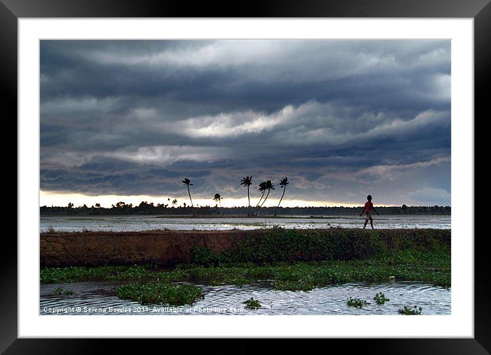 Boy Walking in a Storm, Kerala, India Framed Mounted Print by Serena Bowles