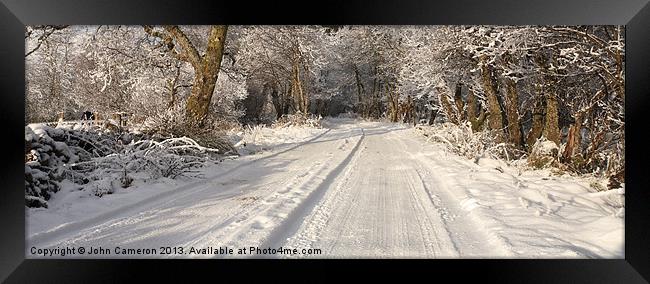 Highland road in winter. Framed Print by John Cameron