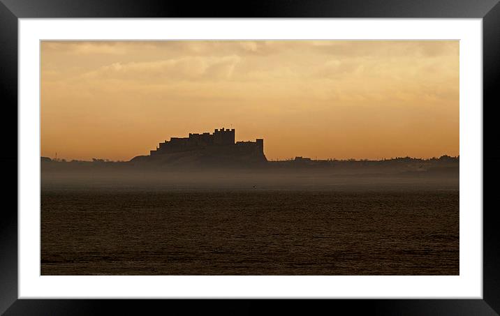 Bamburgh Castle in the mist Framed Mounted Print by John Biggadike