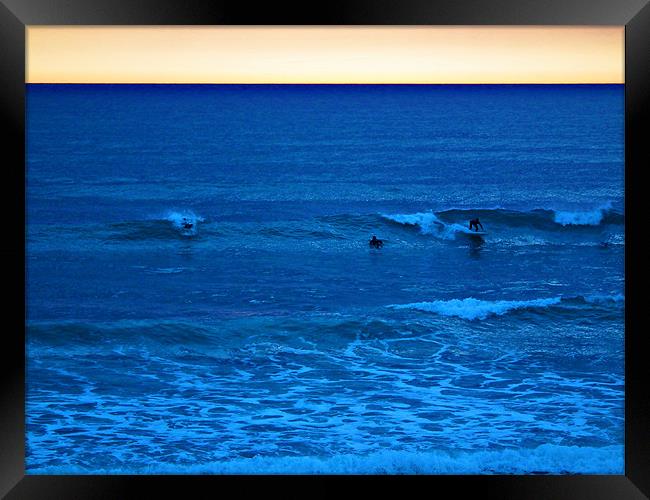 Sunset Surfers Framed Print by Jules Camfield