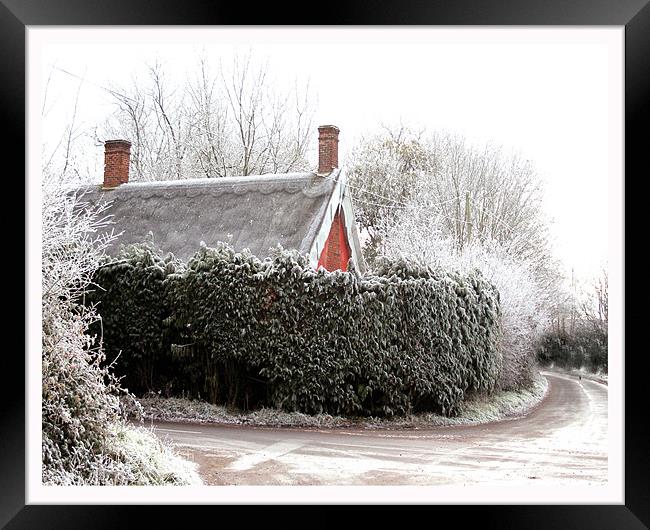 Thatched cottage after a heavy frost Framed Print by Karen Steel