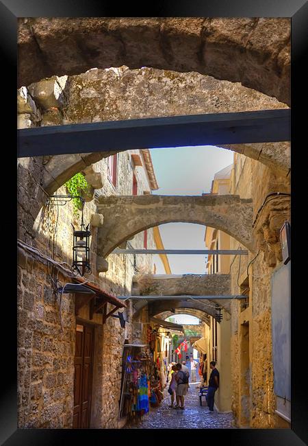 An alley in Rhodes Town Framed Print by Tom Gomez