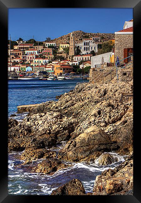 The rocky shore at Nimborio Framed Print by Tom Gomez