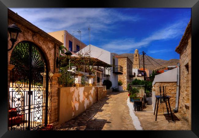 Between the Houses in Halki Framed Print by Tom Gomez