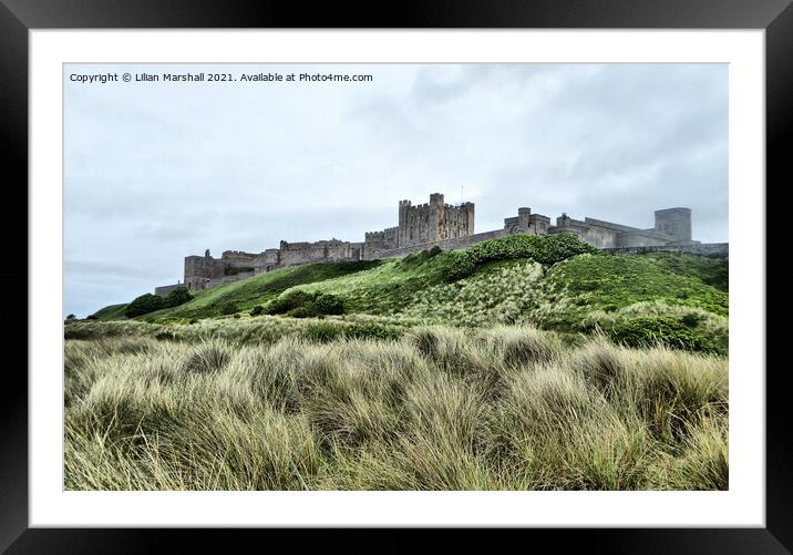 Grey skies over Bamburgh Castle , Northumberland.  Framed Mounted Print by Lilian Marshall