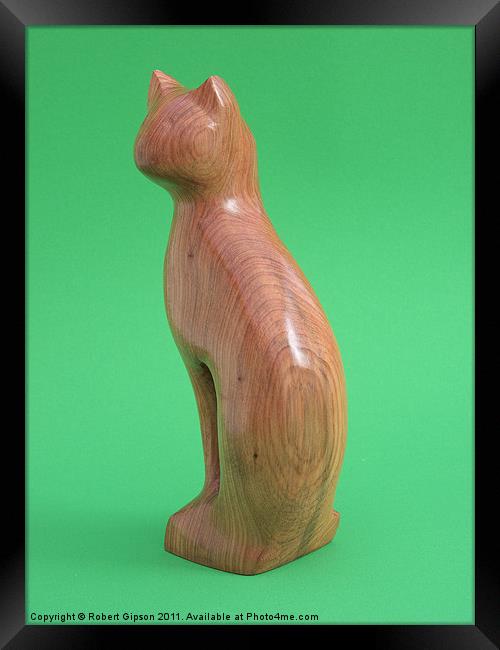 Carved wooden Cat on green Framed Print by Robert Gipson