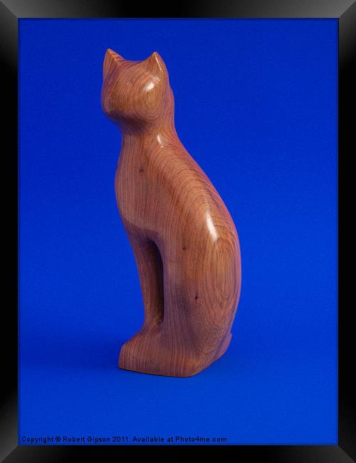 Carved wooden Cat on Blue Framed Print by Robert Gipson