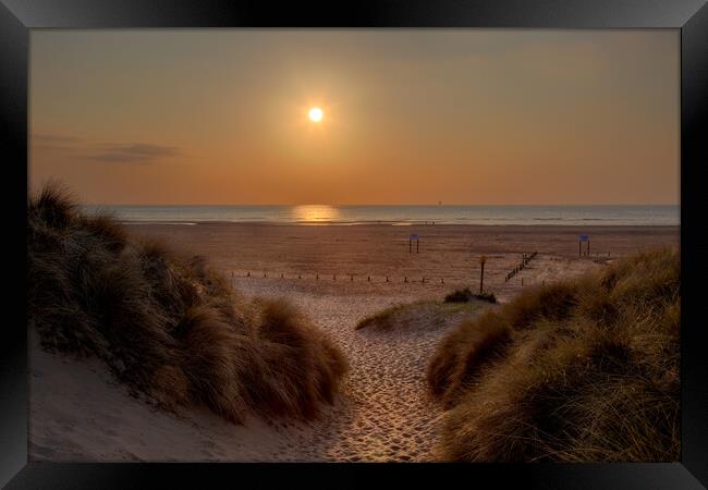 Sunset Through The Dunes Framed Print by Roger Green