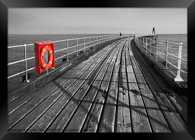Along Whitby pier Framed Print by Stephen Wakefield