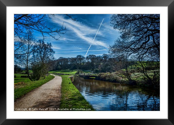 Vapour trails over the canal. Framed Mounted Print by Colin Metcalf