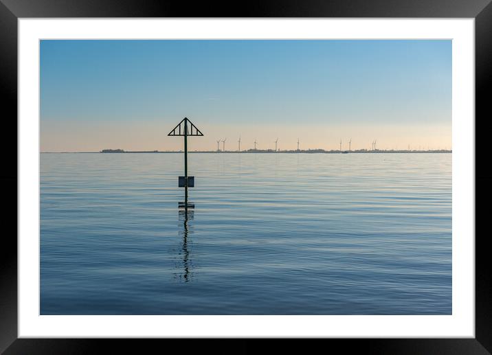 Seashore marker post and wind turbines Framed Mounted Print by Gary Eason