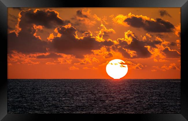 The sun touches the sea Framed Print by Hassan Najmy