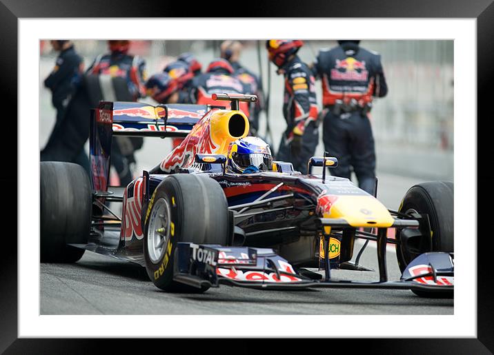 Sebastian Vettel leaving the pits Framed Mounted Print by SEAN RAMSELL