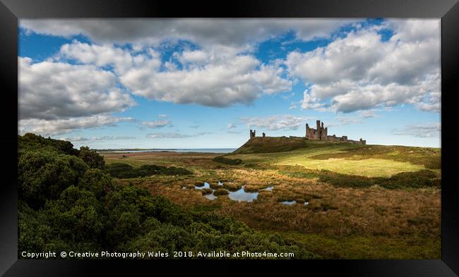 Dunstanburgh Castle on the Northumberland Coast Framed Print by Creative Photography Wales