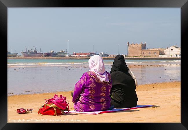 Moroccan women on beach Framed Print by Ian Collins